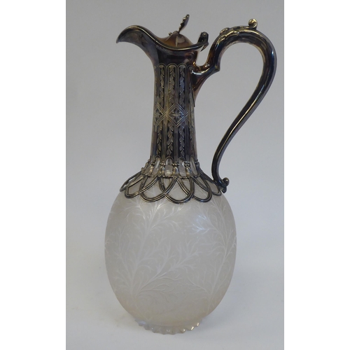 33 - A late Victorian frosted glass wine jug of ovoid form, etched with naturalistically formed foliage, ... 