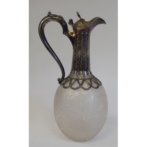 33 - A late Victorian frosted glass wine jug of ovoid form, etched with naturalistically formed foliage, ... 