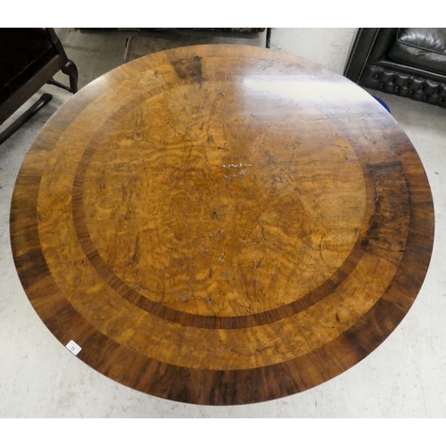 35 - A William IV pollard oak and rosewood centre table, the tip-top with crossbanded border ornament and... 