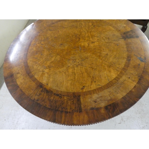 35 - A William IV pollard oak and rosewood centre table, the tip-top with crossbanded border ornament and... 