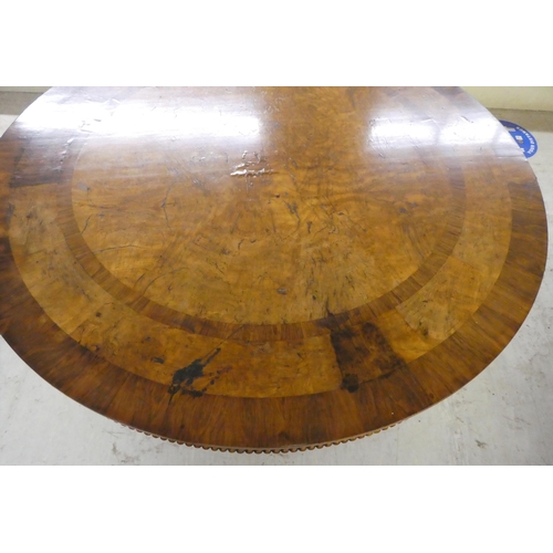 35 - A William IV pollard oak and rosewood centre table, the tip-top with crossbanded border ornament and... 