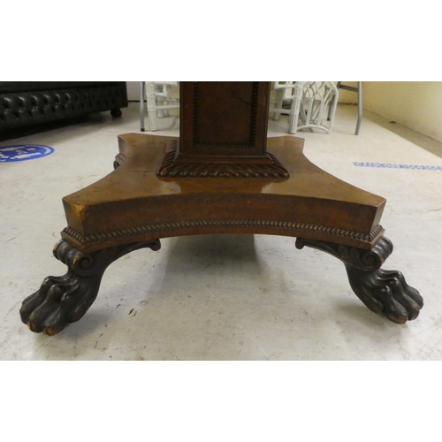 35 - A William IV pollard oak and rosewood centre table, the tip-top with crossbanded border ornament and... 