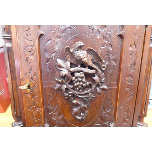 37 - A late 19thC walnut hanging cupboard, the full-height, lockable door enclosed by a panelled door, fe... 