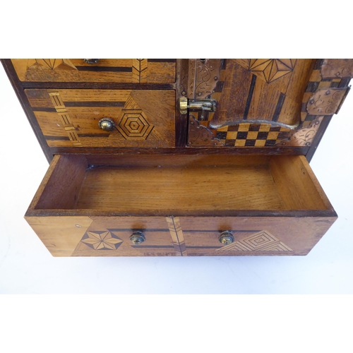 38 - An early 20thC Japanese table-top collector's cabinet, finished in a variety of exotic woods, incorp... 