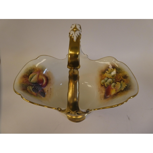 4 - A Royal Worcester china pedestal basket vase with a fixed loop handle, decorated in colours and gild... 