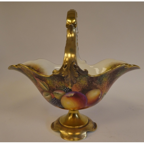 4 - A Royal Worcester china pedestal basket vase with a fixed loop handle, decorated in colours and gild... 