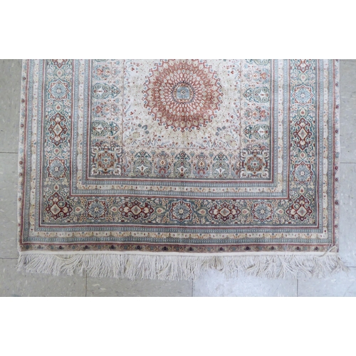 41 - An Iranian silk rug, woven in colours, around a central medallion  36