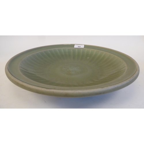 54 - A late 19thC Chinese celadon glazed porcelain, footed, shallow dish with faintly ribbed sides  12