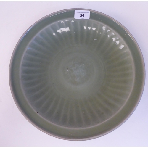 54 - A late 19thC Chinese celadon glazed porcelain, footed, shallow dish with faintly ribbed sides  12