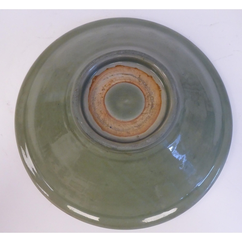 54 - A late 19thC Chinese celadon glazed porcelain, footed, shallow dish with faintly ribbed sides  12