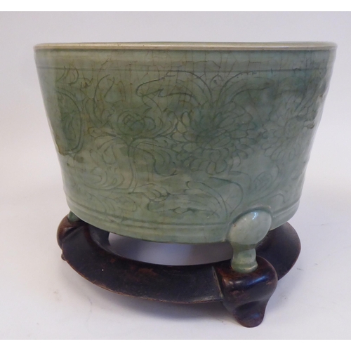 55 - A late 19thC Chinese celadon glazed, etched porcelain jardinière of tapered form with an inve... 