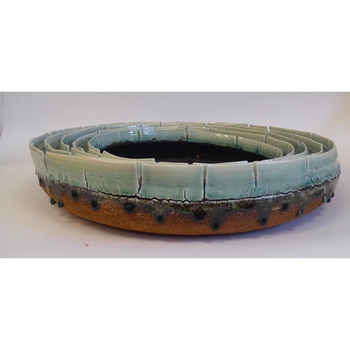 56 - A high fired studio pottery shallow centrepiece bowl, possibly the work of Joan Serra & Mia Laud... 