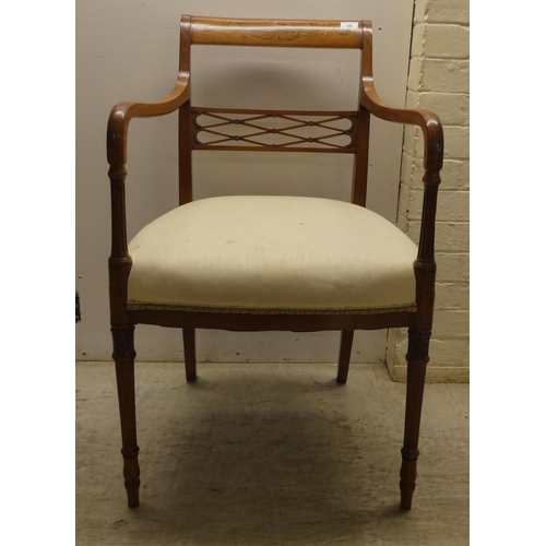 58 - An Edwardian Regency inspired, satinwood framed elbow chair with a decoratively painted crest rail, ... 