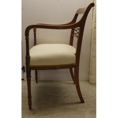 58 - An Edwardian Regency inspired, satinwood framed elbow chair with a decoratively painted crest rail, ... 