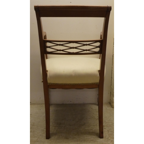 58 - An Edwardian Regency inspired, satinwood framed elbow chair with a decoratively painted crest rail, ... 