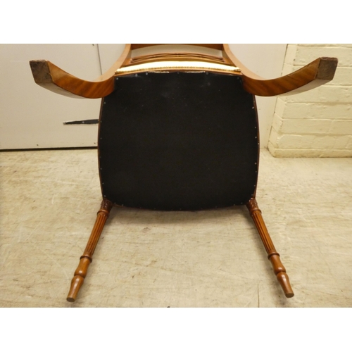 58 - An Edwardian Regency inspired, satinwood framed elbow chair with a decoratively painted crest rail, ... 