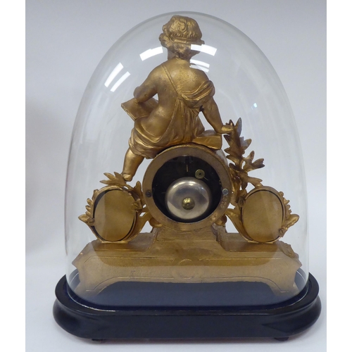 60 - A late 19thC French gilded spelter cased mantel clock, featuring a child reading a book, painted por... 