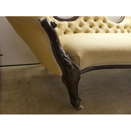 62 - A late Victorian walnut framed chaise longue, button upholstered in beige fabric, raised on cabriole... 