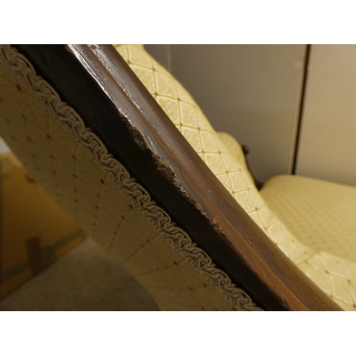 62 - A late Victorian walnut framed chaise longue, button upholstered in beige fabric, raised on cabriole... 