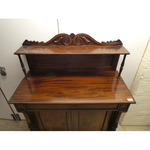 63 - A William IV mahogany chiffonier with a raised back, incorporating a shelf over a frieze drawer and ... 