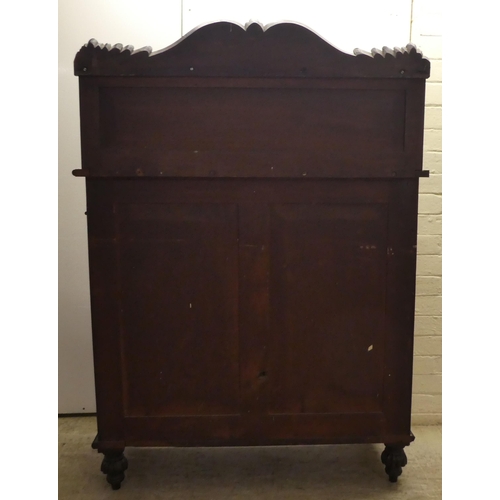 63 - A William IV mahogany chiffonier with a raised back, incorporating a shelf over a frieze drawer and ... 