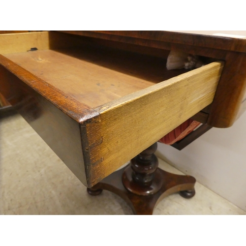 65 - An early Victorian rosewood sewing table with two drawers and a wool basket, raised on a pedestal ba... 