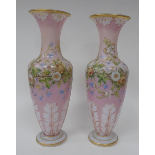 66 - A pair of late 19thC milk glass, gilded and overpainted baluster shape vases with narrow necks and f... 