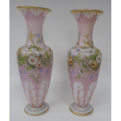 66 - A pair of late 19thC milk glass, gilded and overpainted baluster shape vases with narrow necks and f... 