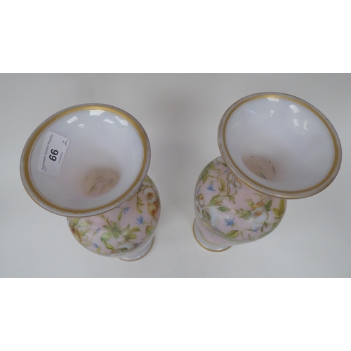 66 - A pair of late 19thC milk glass, gilded and overpainted baluster shape vases with narrow necks and f... 