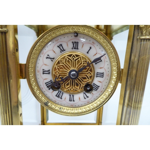 71 - An early 20thC gilt metal cased, four glass mantel clock with bevelled panels, surmounted by a twin ... 