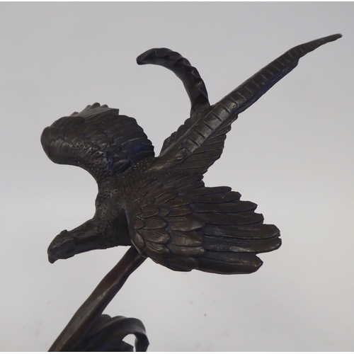 72 - Loet Vanderreen - a cast and patinated bronze group, bird of prey swooping over a water fowl  bears ... 