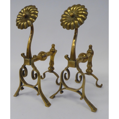 74 - A pair of Arts & Crafts period brass andirons or hearth implement rests with rosette capitals  1... 