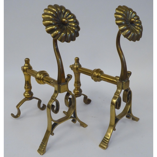 74 - A pair of Arts & Crafts period brass andirons or hearth implement rests with rosette capitals  1... 