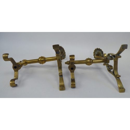 74 - A pair of Arts & Crafts period brass andirons or hearth implement rests with rosette capitals  1... 