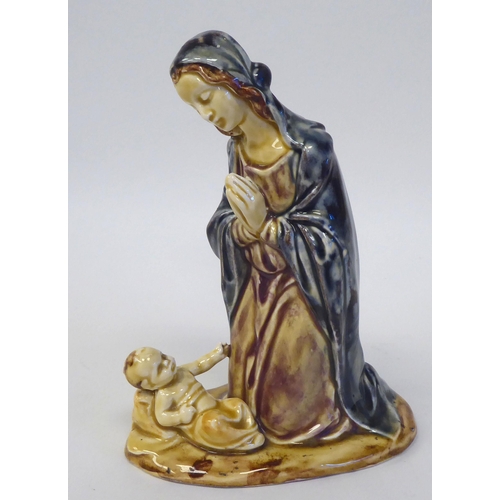 83 - An early 20thC Continental drip glazed pottery group 'Mary and The Christ Child'  bears an indistinc... 