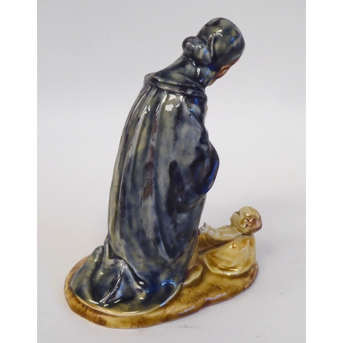 83 - An early 20thC Continental drip glazed pottery group 'Mary and The Christ Child'  bears an indistinc... 