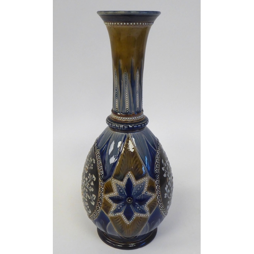 85 - A Doulton Lambeth stoneware bottle vase of ovoid form with a long, narrow neck and flared rim, decor... 