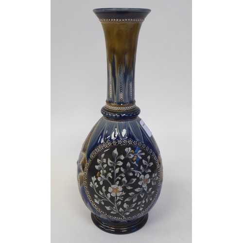 85 - A Doulton Lambeth stoneware bottle vase of ovoid form with a long, narrow neck and flared rim, decor... 