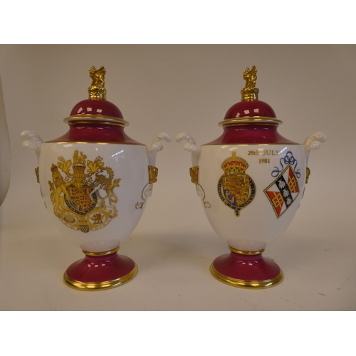 9 - A pair of Royal Worcester china vases of shouldered ovoid form with pedestal covers, decorated with ... 