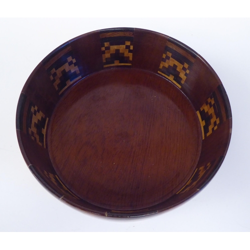 91 - An early 20thC turned fruitwood bowl with straight sides and geometrically arranged marquetry panels... 