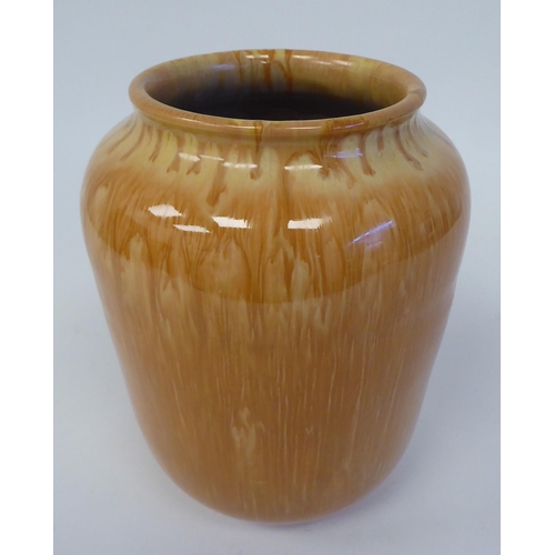 93 - A late 19thC Christopher Dresser drip glazed pottery vase of slightly tapered form with a rolled lip... 