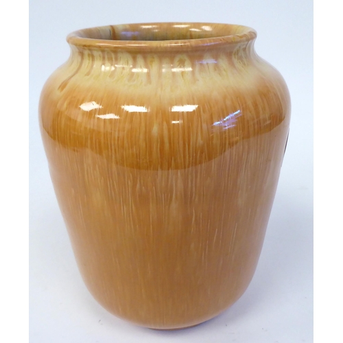 93 - A late 19thC Christopher Dresser drip glazed pottery vase of slightly tapered form with a rolled lip... 