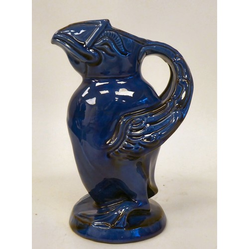 78 - A CH Brannam Barumware blue glazed pottery jug, fashioned as a grotesque puffin  bears an impressed ... 