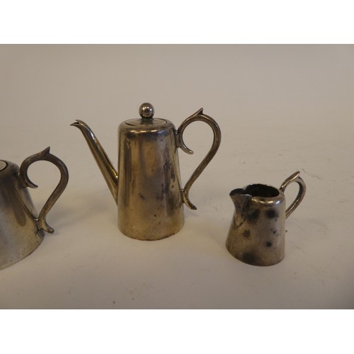 50 - Four items of silver dolls house teaware  comprising a teapot, hotwater pot, sugar basin with tongs ... 