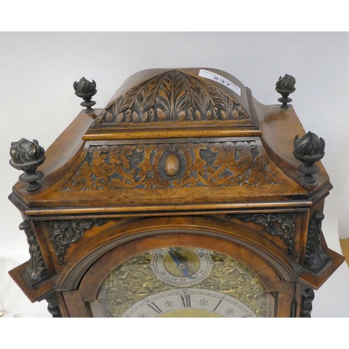 237 - A late 19thC burr walnut cased mantel clock with a domed top, brass finials, grilles and mounts; the... 