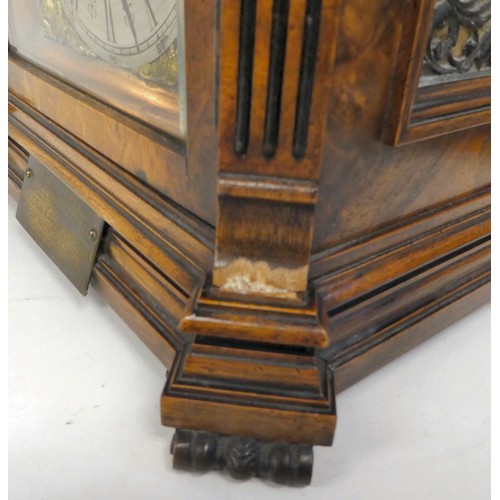 237 - A late 19thC burr walnut cased mantel clock with a domed top, brass finials, grilles and mounts; the... 