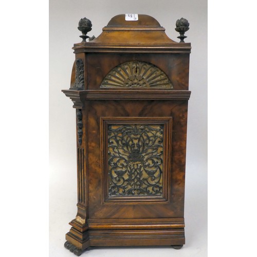 237 - A late 19thC burr walnut cased mantel clock with a domed top, brass finials, grilles and mounts; the... 