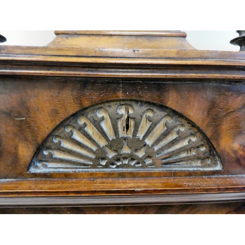 237 - A late 19thC burr walnut cased mantel clock with a domed top, brass finials, grilles and mounts; the... 