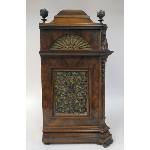 237 - A late 19thC burr walnut cased mantel clock with a domed top, brass finials, grilles and mounts; the... 