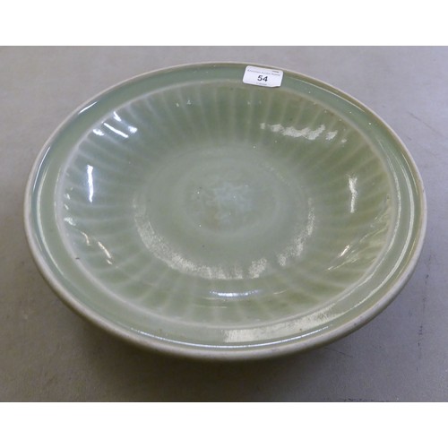 54 - A late 19thC Chinese celadon glazed porcelain, footed, shallow dish with faintly ribbed sides  12